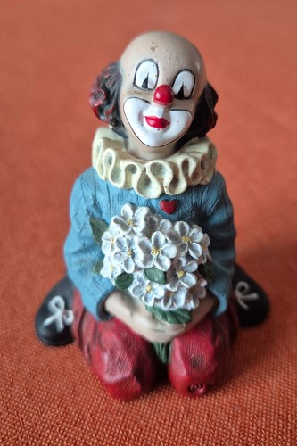 Gilde clown knieend mit blumen - gilde,